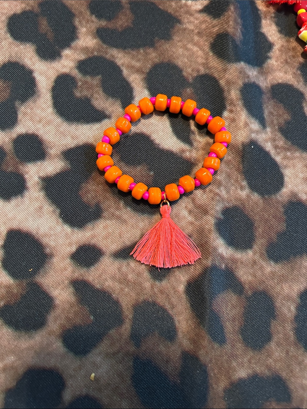 Hand Crafted Orange Beaded Bracelet with Pink Tassel